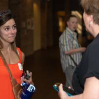 Two people talking in business-casual wear at event